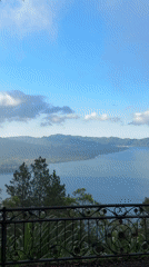 Tourist observes mountain lake vista from Kintamani viewpoint