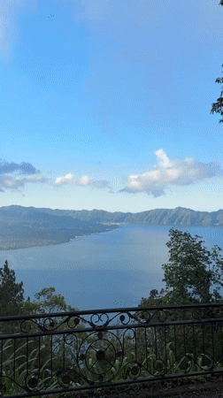 Tourist observes mountain lake vista from Kintamani viewpoint