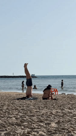 Beachgoers enjoy leisure activities on Tel Aviv shore