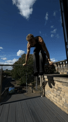 Young man exercises on balcony, takes selfies in London