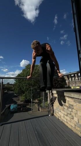 Young man exercises on balcony, takes selfies in London