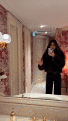 Woman takes selfies in luxurious Paris interior