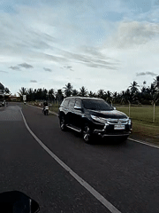 Motorcycle journey captured on rural Indonesian road