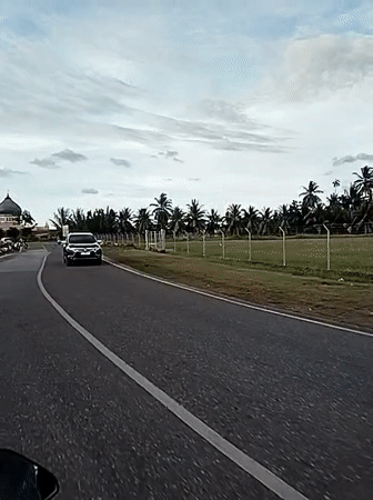 Motorcycle journey captured on rural Indonesian road