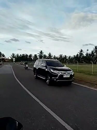 Motorcycle journey captured on rural Indonesian road