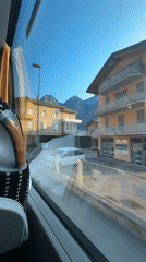 Bus ride through Mezzolombardo past a yellow Cassa Rurale