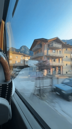 Bus ride through Mezzolombardo past a yellow Cassa Rurale