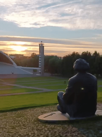 Bronze seated statue on circular stone base, Tallinn
