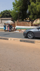 Street vendors gather roadside in Kaduna, Nigeria