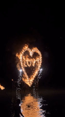 Flaming heart sculpture and fire performance light up Bang Rak Beach