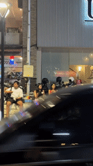 Young adults gather near gelato shop in nighttime Denpasar