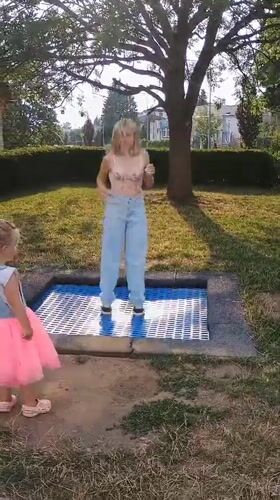 Afternoon park play around a trampoline in Sokolov, Czechia