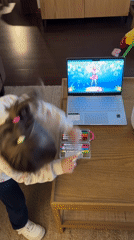 Girl watches cartoon dance video with art supplies in Chile