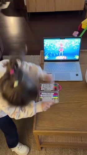 Girl watches cartoon dance video with art supplies in Chile
