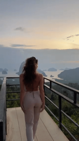 Woman poses on scenic viewing platform in coastal Thailand