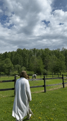 Woman interacts with cattle on rural Russian property