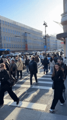 Pedestrians cross sunny Saint Petersburg street on Monday afternoon