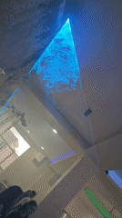 Laser light show displays cyan pyramid patterns in Aytos