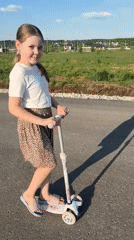 Children play with scooters on sunny Izhevsk streets