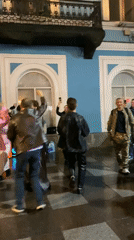Young people dance in circle on Saint Petersburg sidewalk