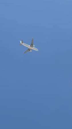 Airplane climbs over a clear blue sky near Egypt's coast