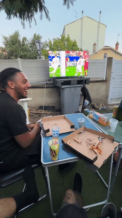 Backyard soccer watch party with pizza and a grill going