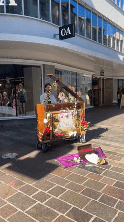 Street organ busker performs in Winterthur pedestrian area