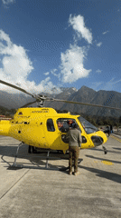 Helicopter operations observed at Lukla helipad amid clear mountain weather