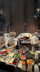 Pizza prep underway in a Đà Nẵng commercial kitchen