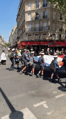 Uniformed youth procession with flags marches through central Paris