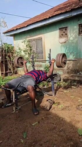 Outdoor bench press workout captured in Akwanga, Nigeria