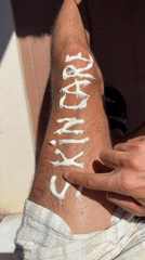 Person writes skincare messages on leg with cream in Milan