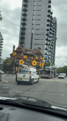 Car stops at crosswalk near Black Friar building in Salford