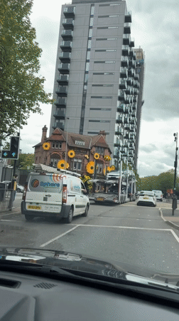 Car stops at crosswalk near Black Friar building in Salford