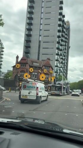Car stops at crosswalk near Black Friar building in Salford