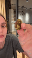 Woman enjoys pistachio-covered chocolate dessert in recorded moment