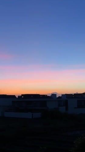 Colorful sunset observed over Mengwi residential area with mountain backdrop