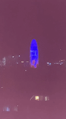 Torre Glòries illuminated in blue and red lights Barcelona
