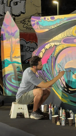 Mural painting, street performance, and moon-gazing in Tel Aviv
