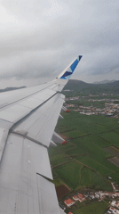 Airplane wing captured from window over Ponta Delgada
