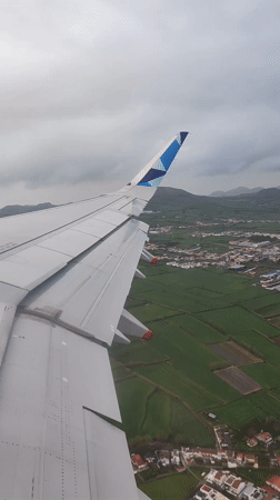 Airplane wing captured from window over Ponta Delgada