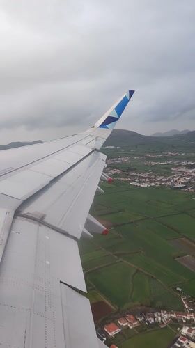Airplane wing captured from window over Ponta Delgada