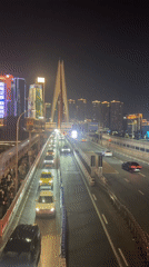Nighttime crowds gather for cultural display in Chongqing's Hongyadong district