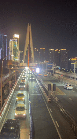 Nighttime crowds gather for cultural display in Chongqing's Hongyadong district