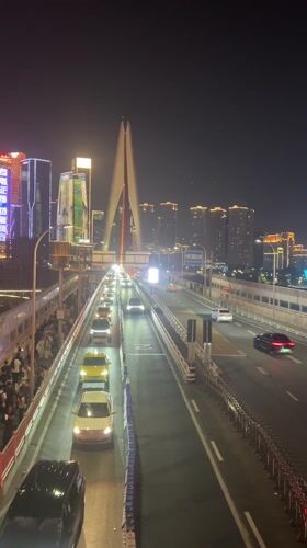 Nighttime crowds gather for cultural display in Chongqing's Hongyadong district