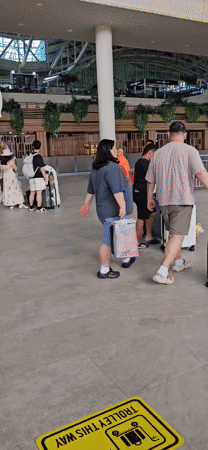 Flight crew and monk observed at Kuta airport terminal