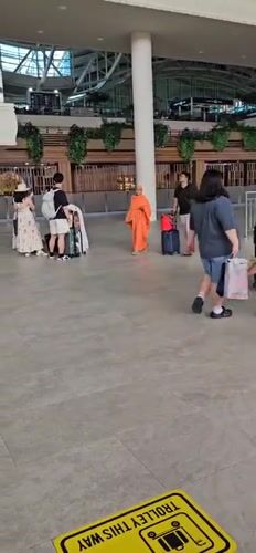 Flight crew and monk observed at Kuta airport terminal