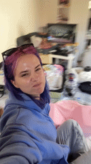 Woman with colorful hair packing in Zagreb room