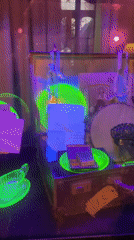 Moody lit display of glass objects and toy scorpions in Melbourne