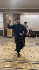 Dance group rehearses in marble hall as subway activity continues